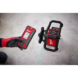 Image of the Milwaukee M18 Green Interior Rotary Laser Level Kit w/ Remote/Receiver & Wall Mount Bracket being used by a worker on a jobsite floor
