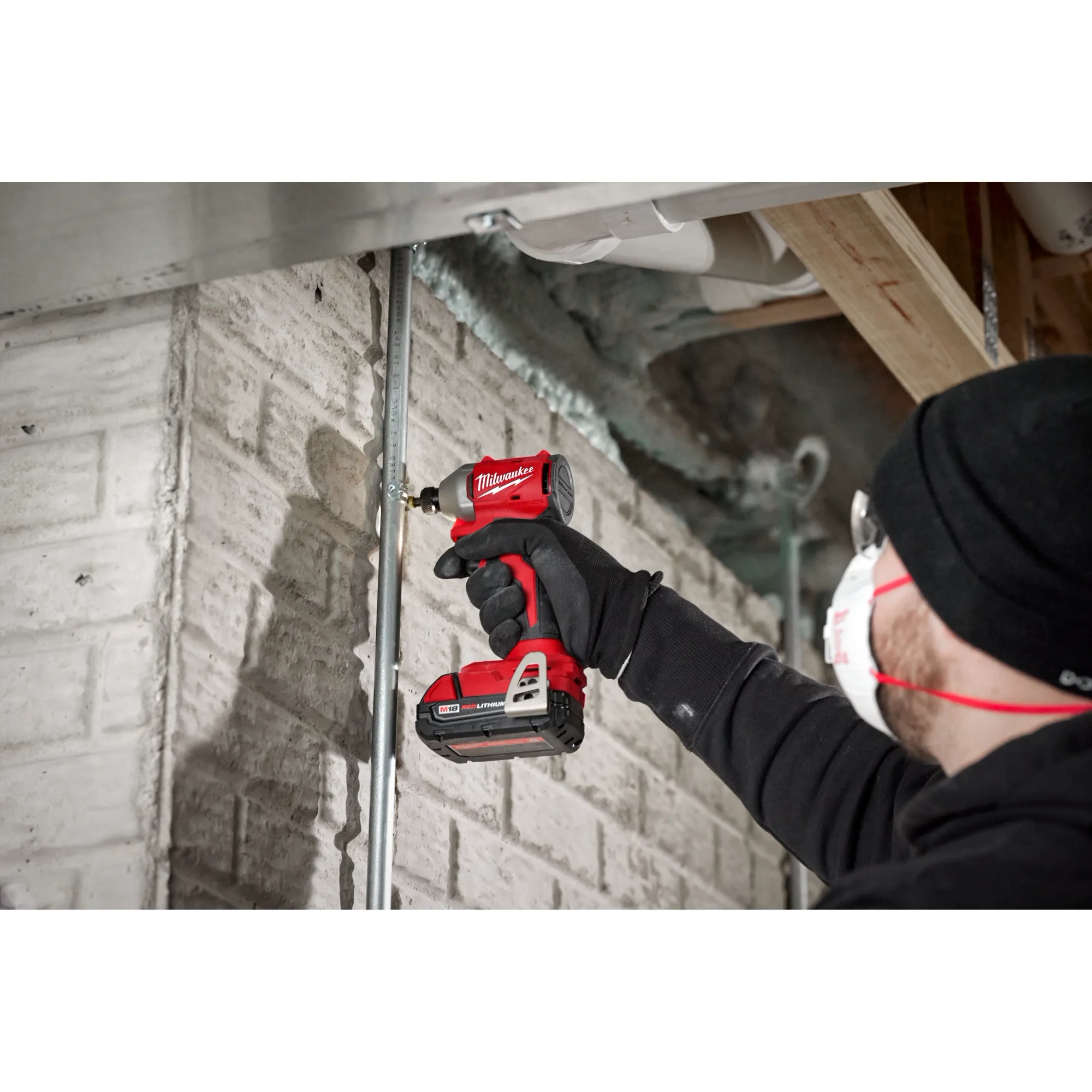 Worker using the Compact Brushless 1/4" Hex 3-Speed Impact Driver to drill a screw into concrete