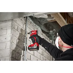 Worker using the Compact Brushless 1/4" Hex 3-Speed Impact Driver to drill a screw into concrete
