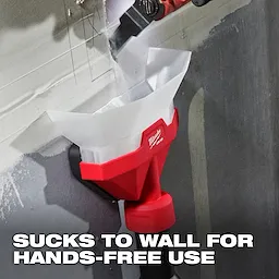 The image shows an AIR-TIP™ Dust Collector in use. It is attached to a wall and collecting dust hands-free. The red and white device has the Milwaukee logo and is actively suctioning dust while a tool works above it. Text on the image reads, "SUCKS TO WALL FOR HANDS-FREE USE."