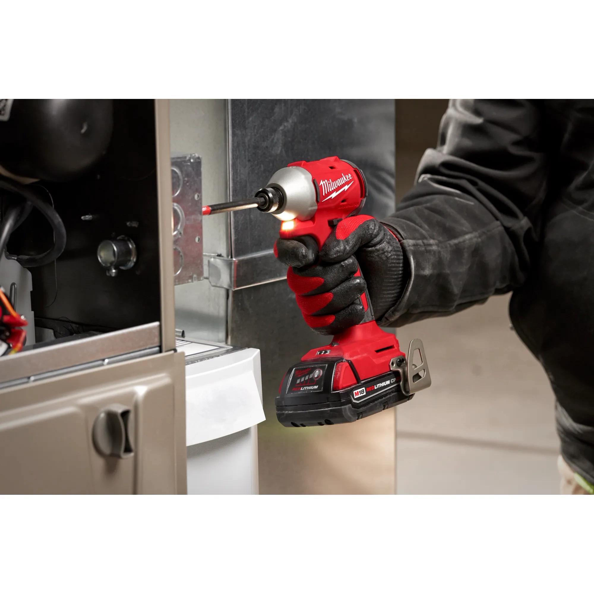 Worker using the Compact Brushless 1/4" Hex 3-Speed Impact Driver and LED light feature