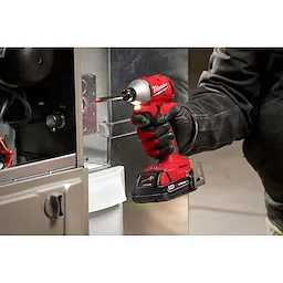 Worker using the Compact Brushless 1/4" Hex 3-Speed Impact Driver and LED light feature